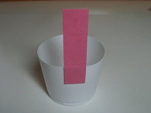 Glue striped paper to the cupcake preparation