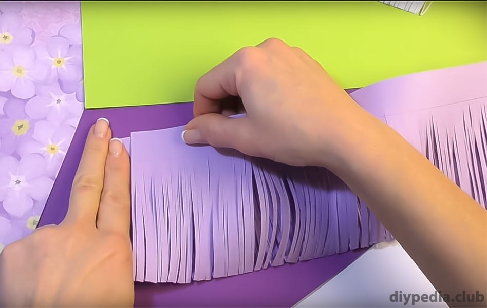 slicing strips of purple paper
