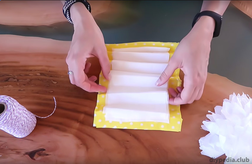 folding the napkin into an accordion