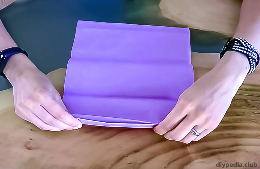 folding sheets of paper for a flower